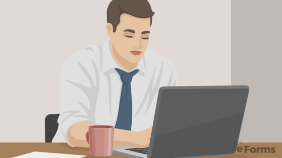 employer typing employee evaluation on laptop