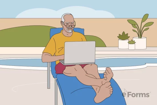 Senior reclining on outdoor lounge while typing on laptop